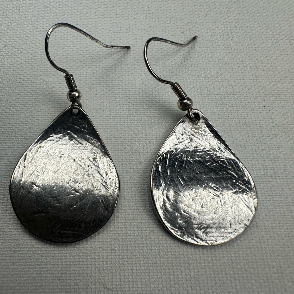 Silver dangle earrings and silver charm. No necklace